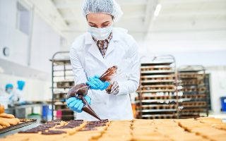 Chef placing chocolate on top of cookies